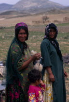 Qashqai nomads on annual immigration through the Zagros Mountains.  Two women and child  three-quarter portrait.2 Children Female Woman Girl Lady Iranian Kids Middle East