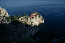 Cap Massulo. Villa Malaparte. Red building built at the end of a cliff surrounded by the Mediterranean sea. Constructed by the architect Adalberto Libera for the writer and journalist Curzio Suckert w...
