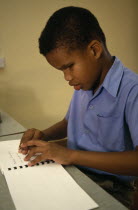Blind boy learning Braille at St Pauls School for the blindCaribbean Grenadian Greneda Immature Kids Lessons One individual Solo Lone Solitary Teaching West Indies