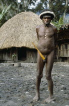 Akima Village.  Dani tribesman wearing penis gourd.Asian One individual Solo Lone Solitary Southeast Asia Southern