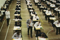 Pupils sitting O level exam watched by invigilators. GCSETest Examination European Kids Learning Lessons Teaching