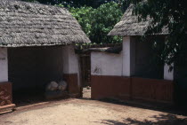 Traditional thatched house with intricate patterns on walls. Ceremonial drums inside one of the huts.African Asante Classic Classical Ghanaian Historical History Older Western Africa 1 Single unitary...