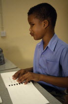 Boy learning Braille at St Pauls School for the blindHandicapCaribbean Grenadian Greneda Kids Lessons One individual Solo Lone Solitary Teaching West Indies 1 Grenada Immature Single unitary