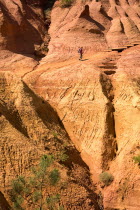 Belvedere Panorama area with figure walking on the sandy red trail of the park. Ochre Trail European French Western Europe