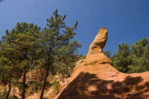 Jagged  eroded outcrop of red rock in the area known as the Holm Oak Valley.Ochre Trail European French Western Europe