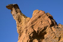 Colorado Provencal.  Cheminee de Fee or Fairy Chimneys.  Angled view of a dramatic capped  ochre rock pinnacle against cloudless blue sky.Ochre Trail European French Western Europe