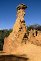 Colorado Provencal.  Cheminee de Fee or Fairy Chimneys.  View of capped  eroded ochre rock pinnacle in evening light.Ochre Trail European French Western Europe Warm Light