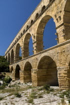 Pont du Gard.  Angled view of three tiers of arches of Roman aqueduct from the west side in glowing evening light.Bridge arch European French Western Europe Warm Light