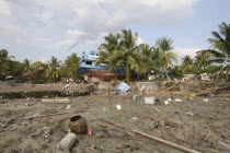Tsunami. Boats have been thrown into the center of the village onto the streets and houses which have also been damaged in the village  not much is left standing in the village. 2500 people are pressu...