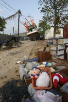 Tsunami. Childrens toys ly piled up and Boats have been pushed onto the streets which have also been damaged in the village  nothing is left standing in the village  2500 people are pressumed dead 125...