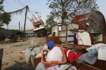 Tsunami. Childrens toys ly piled up and Boats have been pushed onto the streets which have also been damaged in the village  nothing is left standing in the village  2500 people are pressumed dead 125...