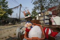 Tsunami. Childrens toys ly piled up and Boats have been pushed onto the streets which have also been damaged in the village  nothing is left standing in the village  2500 people are pressumed dead 125...