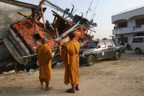 Tsunami. Monks looks at the damage caused by the tsunami  nothing is left standing in the village 2500 people are pressumed dead. 125kms north of Phuket on the 2nd Jan.Asian Ecology Entorno Environme...