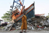 Tsunami. Monk looks at the damage caused by the tsunami  nothing is left standing in the village 2500 people are pressumed dead. 125kms north of Phuket on the 2nd Jan.Asian Ecology Entorno Environmen...