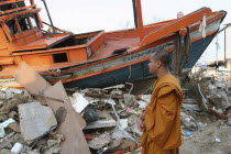 Tsunami. Monk looks at the damage caused by the tsunami  nothing is left standing in the village 2500 people are pressumed dead. 125kms north of Phuket on the 2nd Jan.Asian Ecology Entorno Environmen...