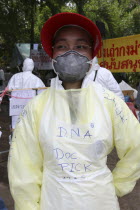 Tsunami. Forensic people and volunteers have to wear masks and suits to work in the area where the bodies are kept for DNA testing for the sanitation  They are also sprayed down when leaving the area....