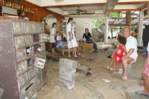 Tsunmai carnage the day after. The owners of Laonte Hotel look on to what is left of there premisis. Patong is the busiest part of Phuket with hotels  bars  and shops in a very tightly condensed area...