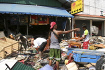 Tsunmai carnage the day after. What is left of Patong on the beach road.People go through the rubble to try and find anythng they can salvage of there belongings. Patong is the busiest part of Phuket...