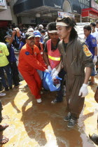 Tsunami carnage the day after. Bodies of foreign tourists are brought out of a flooded supermarket which was in the basement. Patong is the busiest part of Phuket with hotels  bars  and shops in a ver...