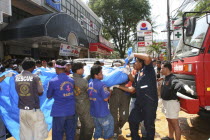 Tsunami carnage the day after. Bodies of foreign tourists are brought out of a flooded supermarket which was in the basement along Patong Beach Road by rescue workers. Patong is the busiest part of Ph...