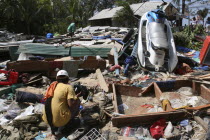 Tsunami carnage the day after. What is left of Patong on the beach road.People go through the ruble to try and find anythng they can salvage of there belongings. Patong is the busiest part of Phuket w...