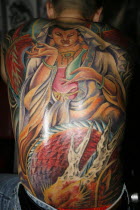 Tattoos on mans back.Asian Southern Prathet Thai Raja Anachakra Thai Siam Southeast Asia