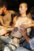 Man having torso tattooed.Asian Southern Male Men Guy Prathet Thai Raja Anachakra Thai Siam Southeast Asia