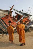 Tsunami. Monks looks at the damage caused by the tsunami  nothing is left standing in the village 2500 people are pressumed dead. 125kms north of Phuket on the 2nd JanAsian Ecology Entorno Environmen...