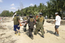 Rescue workers collect Bodies that were out at sea and now litter the coastline. Now the devestation can be seen in the remote areas. This was about 60kms north of Phuket at Khaolak Beach with the des...