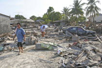 Tsunami. Thais walk through what is left of there vilage  nothing is left standing in the village of Nam Kem  about 125kms north of Phuket.In Phangnga district. On the 31st Dec.Asian Ecology Entorno...