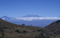 View over landscape toward Kilimanjaro Volcano with the summit visible above the cloudsAfrican Eastern Africa Scenic Tanzanian White