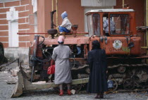 Central Museum of the Revolution with two women standing by children playing on disused tractor2 Eastern Europe Europe & Asia Female Woman Girl Lady Kids Moskva Rossija Rossiya Russian