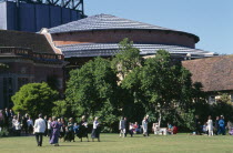 New theatre  exterior with audience members crossing the lawn in front.European Great Britain Northern Europe Performance Theater UK United Kingdom British Isles Public Presentation