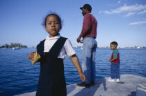Father and children standing on wharf.Family Bermudian Dad Kids West Indies