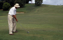 Man playing golf on the Mid-Ocean Golf CourseBermudian Male Men Guy One individual Solo Lone Solitary West Indies 1 Male Man Guy Single unitary