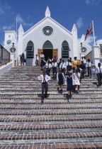 Schoolchildren in uniform leaving St. Peters Cathedral.Bermudian Kids Learning Lessons Religion Religious Teaching West Indies