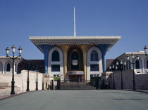 Brightly colored architecture seen across lampost lined bridge Coloured Middle East Omani