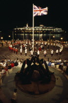 Band of the Bermuda Regiment performing Beat the Retreat a musical call under spotlight which derives from a British Army tradition.Bermudian Performance West Indies Public Presentation