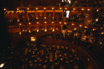 Interior of auditorium with audience members taking their seats before Opera performance.European Great Britain Northern Europe Public Presentation UK United Kingdom British Isles