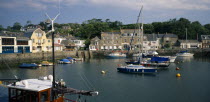 View across the harbour with fishing boats and yachts towards waterside buildingsEuropean Great Britain Northern Europe UK United Kingdom