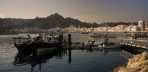 Mutrah Fish Market.  Fishing boats landing catch with waterside buildings behind.Middle East Omani Scenic