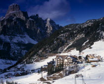 Corvara.  Hotels and other buildings in snow covered valley with mountains behind.European Italia Italian Scenic Southern Europe