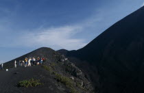 View of people hiking up an ash path to the summit  stoped to take pictures.American Central America Hispanic Latin America Latino Scenic Southern