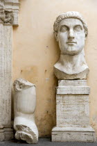 The courtyard of the Palazzo dei Conservatori part of the Capitoline Museum with the head and arm of the colossal 4th Century statue of Emperor Constantine IEuropean Italia Italian Roma Southern Euro...