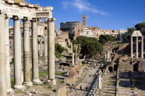 The Forum with the Colosseum rising behind the bell tower of Santa Francesca Romana with the columns of The Temple of Saturn on the left and the three Corinthian columns of the Temple of Castor and Po...