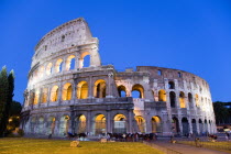 The Colosseum illuminated at night with tourists walking around itEuropean Italia Italian Roma Southern Europe History Holidaymakers Nite Tourism