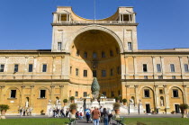 Vatican City Museum The central niche designed by Pirro Ligorio in the Belvedere palace housing the Cortile della Pigna a giant bronze pine cone from an ancient Roman fountain with tourists walking in...