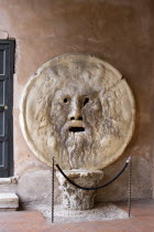 The Bocca della Verita or Mouth of Truth thought to be a medieval drain cover in the portico of the church of Santa Maria in Cosmedin. Tradition had it that the mouth would close over the hands of tho...
