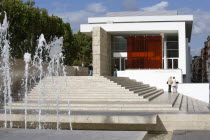 The fountain and steps with sightseers leading to the building hosuing the Ara Pacis or Altar of Peace built by Emperor Augustus to celebrate peace in the Mediteranean. The red prespex cube is part of...
