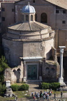 Tourists in the Forum outside the 4th Century Temple of Romulus which survived as part of the attached church of Santi Cosma e DamianoEuropean Italia Italian Roma Southern Europe History Holidaymaker...